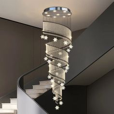 a chandelier hanging from the side of a stair case