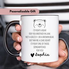 a person holding a white coffee mug with a bear on it's side and the words, personalized gift