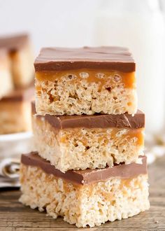 three pieces of rice krispy treats stacked on top of each other with chocolate in the middle