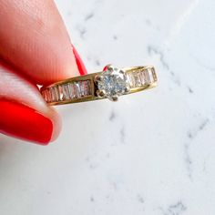 Princess cut & Baguettes Vintage Engagement Ring 14K Yellow Gold Center stone Round Diamond 0.25Ct I Color IS1 Baguette Diamond side stones 0.30Ct J/I Color SI1/SI2 3.4gm Size 7.25 Sizing available with fee contact us to have it added to the price before check out. Thank you for visiting our shop! Visit our website DmKJewelry.com Also Follow us on Instagram https://www.instagram.com/dmkjewelry_/ Dazzling Baguette Diamond Ring For Anniversary, Dazzling Round Cut Diamond Ring With Baguette Diamonds, Dazzling Round Cut Baguette Diamond Ring, White Gold Cluster Ring With Baguette Diamonds, White Gold Baguette Cut Cluster Ring, 14k Gold Cluster Ring With Baguette Cut Center Stone, Yellow Gold Cluster Ring With Brilliant And Baguette Cut, Yellow Gold Cluster Ring With Baguette And Brilliant Cut, Yellow Gold Diamond Ring With Baguette Diamonds