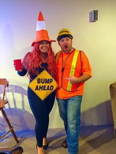 a man and woman dressed up as construction workers pose for a photo together in front of a sign that says bump ahead