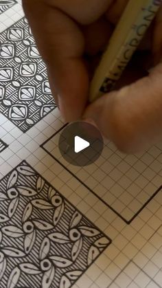 someone is drawing on paper with a pencil