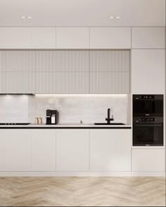 a modern kitchen with white cabinets and black appliances