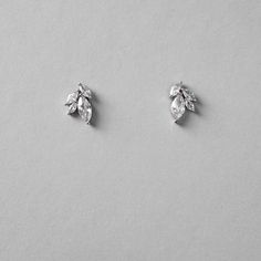 Petite leaf cluster CZ earrings for the bride or bridesmaid set in silver. They are about .5 inches long, lead, nickel, and cadmium free. Made with AAA grade cubic zirconia. Silver Sterling Cluster Earrings For Weddings, Silver Sterling Silver Cluster Earrings For Wedding, Sterling Silver Cluster Earrings With Sparkling Stones For Wedding, Wedding Cluster Earrings With Sparkling Stones In Sterling Silver, Wedding Sterling Silver Cluster Earrings With Sparkling Stones, Silver Marquise Crystal Earrings For Formal Occasions, Silver Marquise Bridal Earrings For Wedding, Silver Leaf-shaped Earrings For Wedding, Silver Marquise Diamond Earrings For Wedding