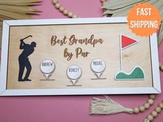 a wooden sign with the words best grandpa by par on it and three golf pins