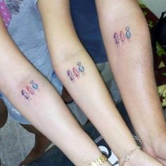 three people with matching tattoos on their arms