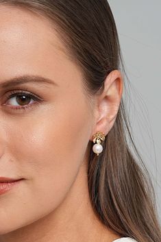 Description Adorn yourself with our floral-inspired pearl earrings, a serene reflection of nature's beauty. As the day unfolds, their delicate design captures the essence of blooming flowers, imparting a quiet confidence. More than accessories, they symbolize your journey with elegance, strength, and resilience—a subtle, empowering radiance for every step you take. Material Freshwater Pearls: We use cultured pearls from oysters and freshwater mussels that we handpicked for our pieces. These fres Elegant Flower Earrings With Pearl Charm, Elegant Flower Shaped Earrings With Pearl Charm, Elegant Flower-shaped Earrings With Pearl Charm, Elegant Flower-shaped Pearl Charm Earrings, Elegant Yellow Gold Flower Pearl Earrings, Elegant Yellow Gold Flower-shaped Pearl Earrings, Elegant Single Flower Earring For Anniversary, Elegant Yellow Gold Flower Earrings With Pearl Drop, Freshwater Mussels