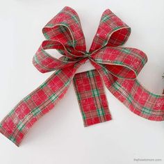 a red and green plaid ribbon with a bow