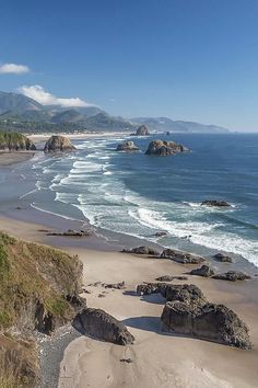 the beach is next to some rocks and water