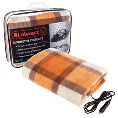 an orange and brown plaid blanket next to a black corded charger on a white background