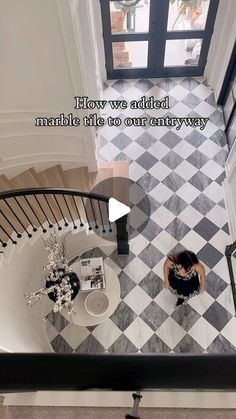 an aerial view of a woman walking down the stairs