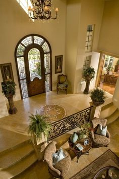 an aerial view of a living room and entryway with stairs leading up to the second floor