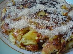 a white plate topped with food covered in powdered sugar