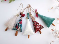 four christmas tree ornaments hanging from twine