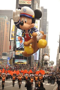 mickey mouse balloon floats down the street in new york city's times square on thanksgiving day