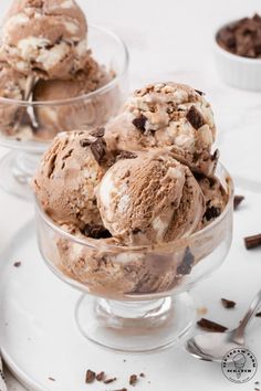 three scoops of french silk ice cream in a glass dish with chocolate chunks on the side