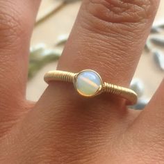 22.00 GBP This beautifully simple wire wrapped ring is lovingly handmade with a Opalite Moonstone and a choice of 14k Gold Filled, 14k Rose Gold Filled or Sterling Silver ​band. M A T E R I A L S: • Opalite Moonstone • 14k Gold Filled, 14k Rose Gold Filled or Sterling Silver S I Z E: • Gemstone - Approximately 4mm All of our jewellery is carefully handmade using good quality materials and handpicked gemstones, with the aim to produce quality pieces that you can love & wear for years to… Opalite Ring, Peruvian Jewelry, Pink Gemstone Necklace, Aluminum Jewelry, White Jewelry Box, Pink Tourmaline Ring, Wire Wrapped Ring, Sterling Silver Wire Wrap, Wire Wrapped Rings