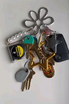 a bunch of keys laying on top of each other next to a keychain