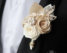 a man in a tuxedo is wearing a boutonniere with flowers on it