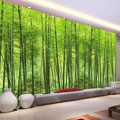 a living room filled with lots of furniture and walls covered in green bamboo tree wallpaper