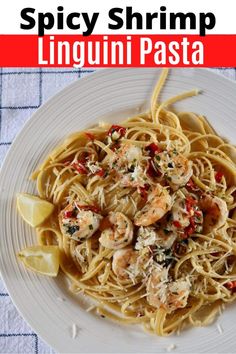 a white plate topped with pasta and shrimp