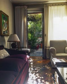 a living room filled with furniture next to a doorway