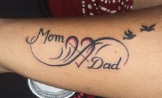 a woman with a tattoo on her arm that says mom and dad in cursive writing