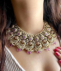 Adorn yourself in timeless elegance with this exquisite lilac purple necklace set, perfect for weddings and special occasions. Crafted with meticulous attention to detail, the set features soft lilac hues reminiscent of Pakistani and Punjabi traditions, with a touch of Bollywood glamour. Complete with matching earrings and a stunning maangtika, this Indian Kundan ensemble effortlessly captures the essence of sophistication and grace. Measurements:  Necklace Weight-150 gms  Necklace width- 11 inc Elegant Purple Kundan Necklace For Festive Occasions, Elegant Purple Jewelry Set For Festive Occasion, Elegant Purple Kundan Necklace As Gift, Purple Kundan Jewelry For Diwali, Elegant Purple Kundan Necklace For Wedding, Pink Intricate Design Necklace For Wedding, Elegant Purple Meenakari Jewelry, Festive Purple Chandbali Jewelry, Purple Necklaces With Intricate Design For Wedding