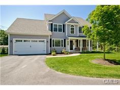 a large gray house with two garages