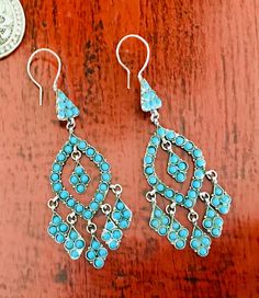 Vintage Afghan Turquoise Chandelier Silver Earrings These genuine, beautifully detailed handmade turquoise chandelier earrings are simply superb.  Lightweight in excellent condition. You will be hard pressed to find these anywhere else on Etsy.  Overall length: 9cm Width: 3cm at widest point I do my best to depict the true colour in my photography as possible. ♥️Thanks for stopping by. I'm always available for any questions you may have!♥️ Traditional Turquoise Dangle Chandelier Earrings, Traditional Turquoise Danglers For Gift, Traditional Blue Drop Chandelier Earrings, Bohemian Turquoise Earrings With Intricate Design, Turquoise Bohemian Earrings With Intricate Design, Traditional Chandelier Earrings With Blue Dangling Beads, Blue Dangle Earrings With Intricate Design, Handmade Traditional Turquoise Chandelier Earrings, Chandelier Silver