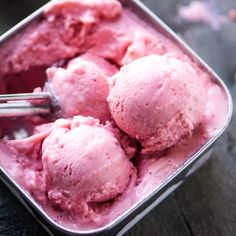 two scoops of strawberry ice cream in a tin