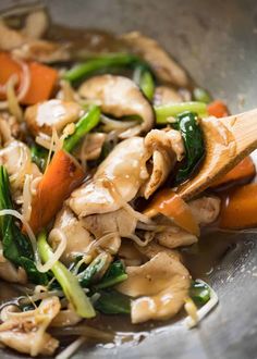 a stir fry with chicken, carrots and spinach