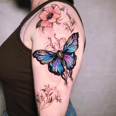 a woman with a butterfly tattoo on her arm