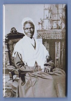 an old photo of a woman sitting in a chair