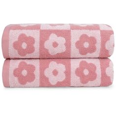 two pink towels with white flowers on them