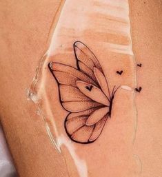 a woman's stomach with a butterfly tattoo on it