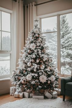 a decorated christmas tree in front of a window