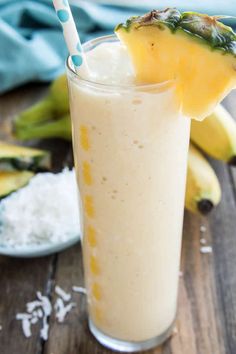 a smoothie is garnished with pineapple and bananas