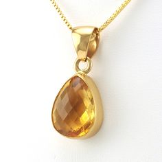 This genuine checkerboard cut citrine teardrop gemstone is set in alchemía. Pendant is 1 3/8 inches long and 5/8 inch wide and is sold separate from the 18k gold fill 1.2mm box chain shown. Alchemía a blend of base metals that looks like 18k gold and will not change color and is hypoallergenic.  Style Number: 19201 Met Teardrop Citrine Gemstone Jewelry, Teardrop Faceted Citrine Jewelry, Faceted Teardrop Citrine Jewelry, Pear-shaped Citrine Jewelry In Yellow Gold, Yellow Gold Pear-shaped Citrine Jewelry, Gold Citrine Drop Jewelry, Faceted Teardrop Pendant In Yellow Gold, Teardrop Citrine Jewelry For Gifts, Pear-shaped Citrine Gemstone Jewelry