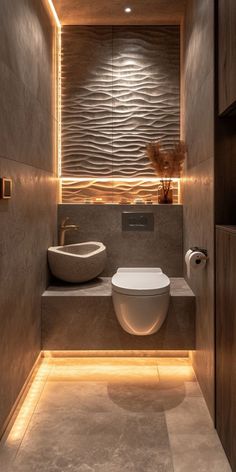 a bathroom with a toilet, sink and lights on the wall above it's counter