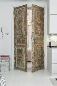 an open wooden door in a white room