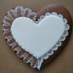 a heart shaped cookie sitting on top of a table