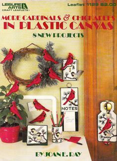 a magazine cover with red birds on the front and back covers, surrounded by christmas decorations