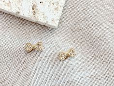 Tiny ribbon earrings Gold Dainty Bow Earrings, Gold Dainty Earrings With Bow, Dainty Gold Earrings With Bow, Dainty Gold Bow Earrings, Cute Gold Bow Earrings, Gold Earrings With Bow Tie Detail For Gift, Gold Bow Tie Earrings For Gift, Cute Anniversary Jewelry With Bow, Ribbon Earrings