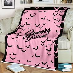 a pink and black blanket with bats on it