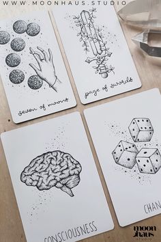 four coasters with different types of dice and brain images on them, sitting on a table