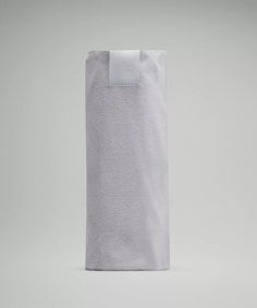 a white towel folded up against a gray background