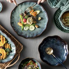 several plates with different types of food on them, including salads and soups