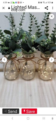 four glass vases with plants in them on a table