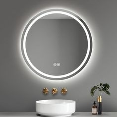 a bathroom with a round mirror above the sink